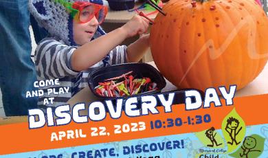 Discovery Day at CDC child playing with a pumpkin