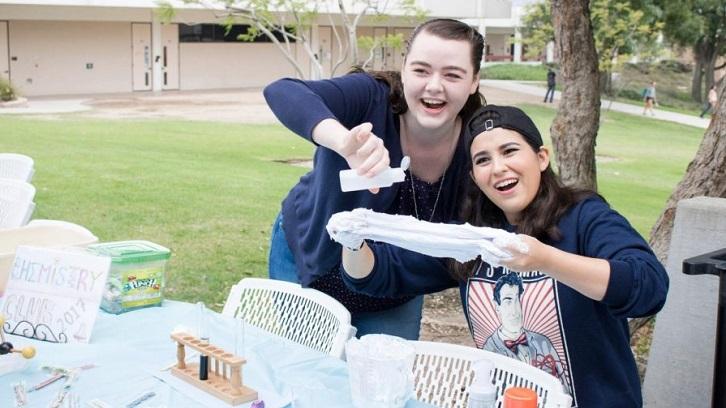 19-year-old Materials Engineering major Erika Szaldobagyi, left, and 19-year-old Chemistry major Amanda Davis, right, show off their love for chemistry in the form of slime made from common household products. Photo credit: Martin Bilbao