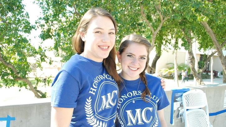 Members of the Honors Club table at an outreach event.