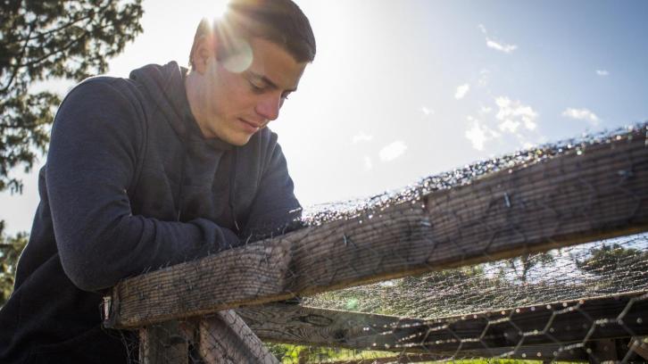 Nature's Finest club president Nick Boomhower tends to a garden plot.