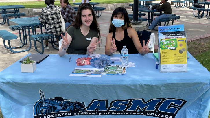 Students table at an ASMC event.