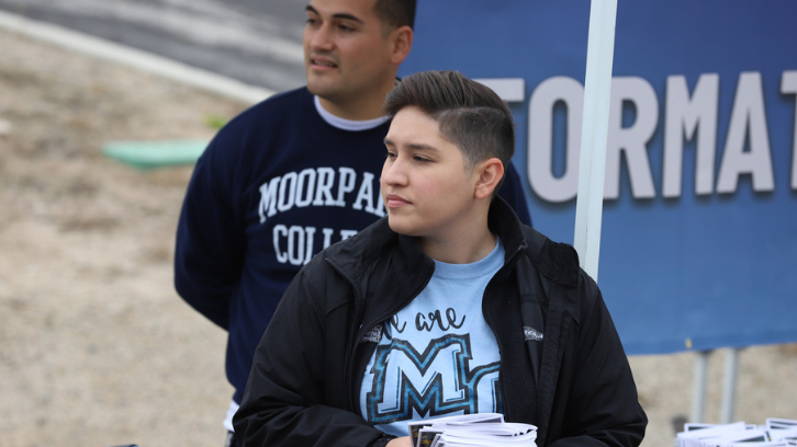 Staff distribute programs to guests at Commencement.