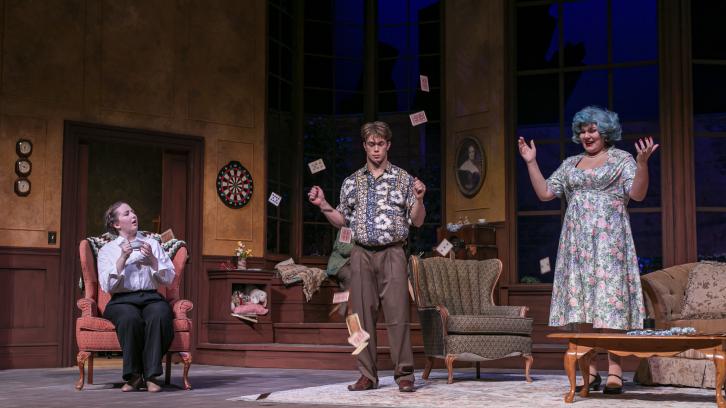 Cast throwing cards in the air