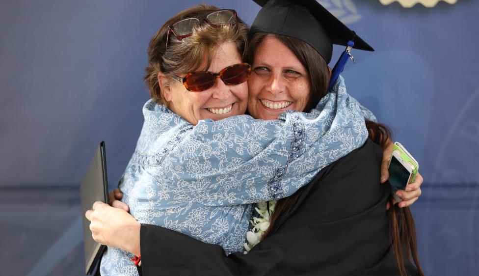Moorpark College Graduate embracing a family member.