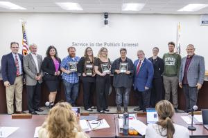 Classified Employee of the Year nominees stand holding plaqu Classified Employee of the Year nominees stand holding plaqu