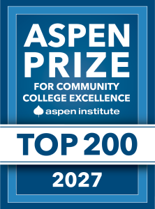 Blue and white graphic badge that reads: “Aspen Prize for Co Blue and white graphic badge that reads: “Aspen Prize for Co