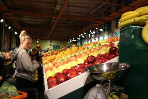 A young adult shopping for produce.