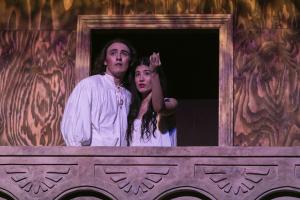 Two theatre students on a stage balcony.