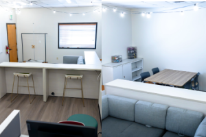 Inside the Campus Pride Center, computer stations, counter work spaces, tables for group collaboration, resources, and a couch